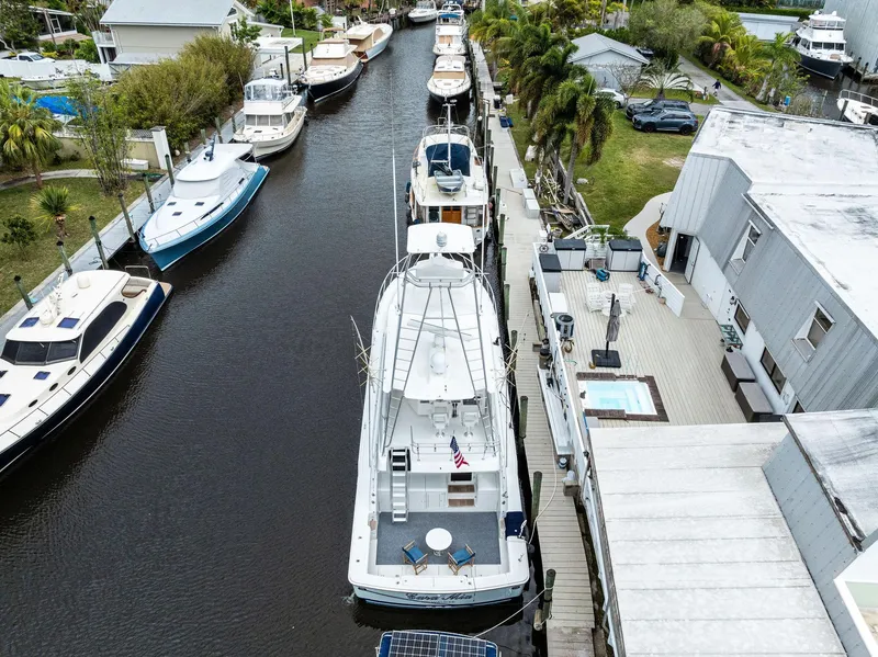 Slide: The Image of Aerial view of a 2003 Bertram 570 Moppie yacht docked in a canal. - 5