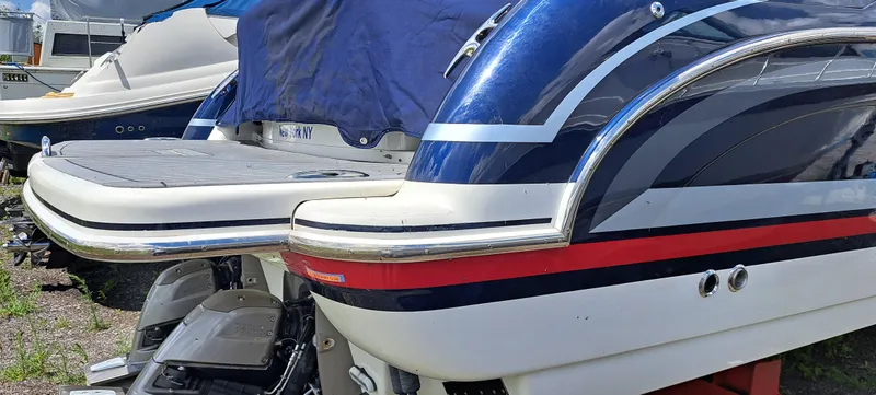 Slide: The Image of 2018 Formula 400 Super Sport boat, rear view, blue and white design, docked outdoors. - 10