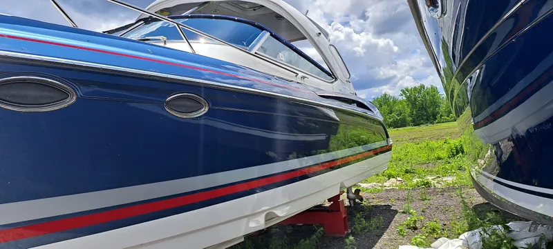 Slide: The Image of 2018 Formula 400 Super Sport boat with sleek blue and red design, parked outdoors. - 11