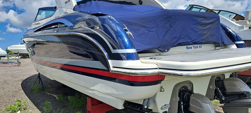 Slide: The Image of 2018 Formula 400 Super Sport boat with blue cover, parked outdoors. - 13