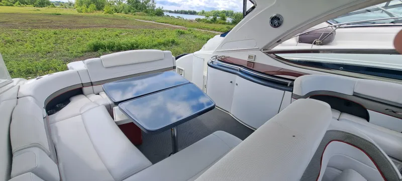 Slide: The Image of 2018 Formula 400 Super Sport yacht interior with white seating and dual tables. - 19