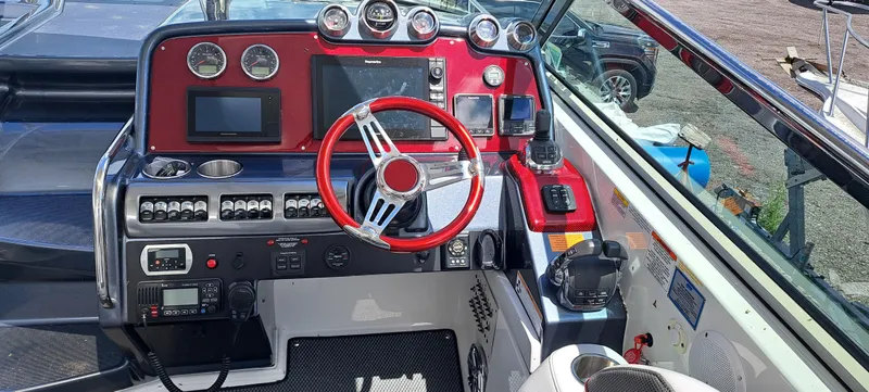 Slide: The Image of 2018 Formula 400 Super Sport boat dashboard with red accents and modern controls. - 21