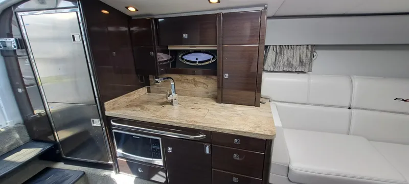 Slide: The Image of 2018 Formula 400 Super Sport yacht interior with modern kitchen and seating area. - 33
