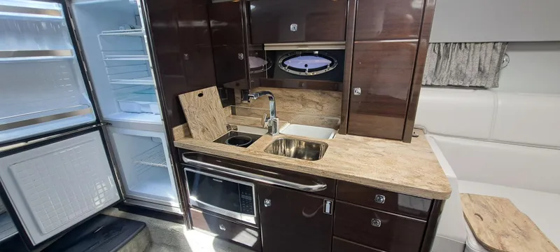 Slide: The Image of 2018 Formula 400 Super Sport yacht interior kitchen with modern appliances and wood finish. - 34