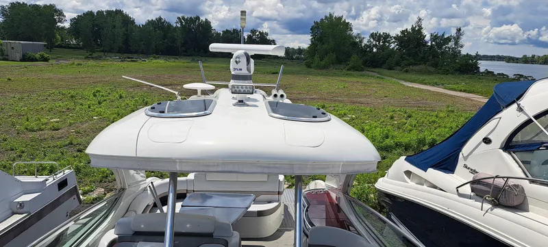 Slide: The Image of 2018 Formula 400 Super Sport boat docked near lush greenery and other boats. - 43