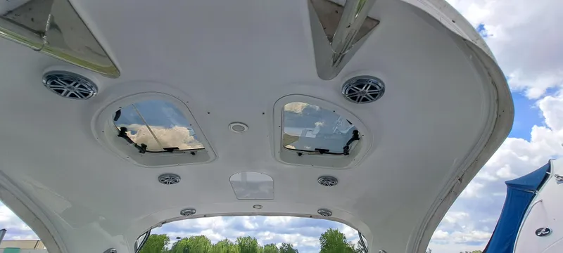 Slide: The Image of 2018 Formula 400 Super Sport boat ceiling with skylights and speakers, under a partly cloudy sky. - 44