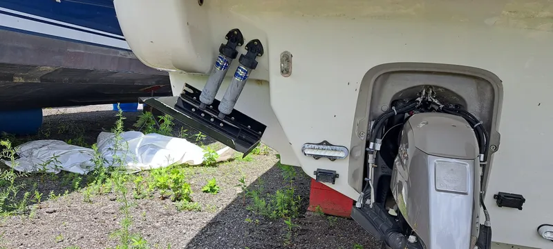 Slide: The Image of 2018 Formula 400 Super Sport boat engine and trim tabs in a yard setting. - 45