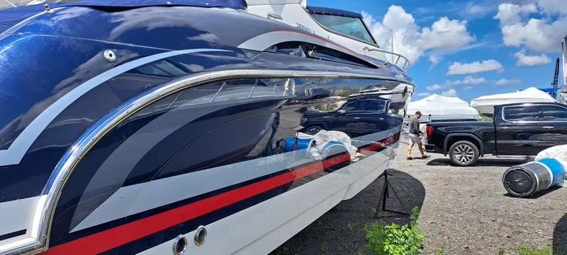 Slide: The Image of 2018 Formula 400 Super Sport boat with sleek design, parked outdoors under blue sky. - 9