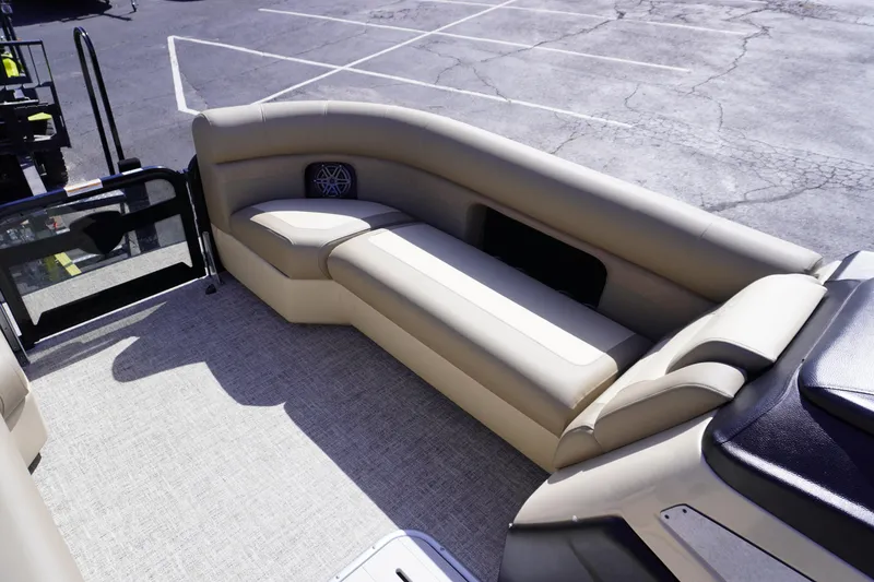 Slide: The Image of 2025 Premier 250 Sunsation RS boat interior with beige seating and carpeted flooring. - 11