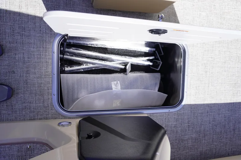 Slide: The Image of Storage compartment of 2025 Premier 250 Sunsation RS boat with metal poles inside. - 20