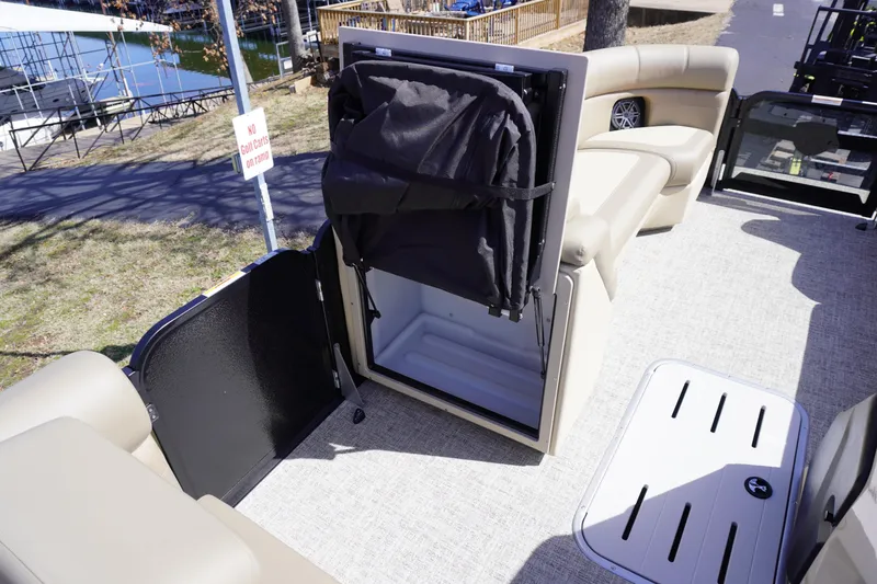 Slide: The Image of 2025 Premier 250 Sunsation RS pontoon boat interior with storage compartment open. - 21
