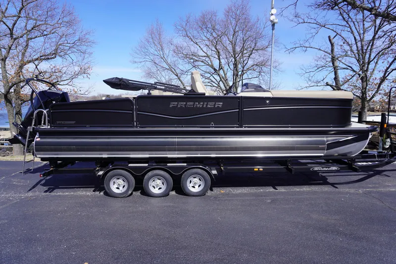 Slide: The Image of 2025 Premier 250 Sunsation RS pontoon boat on trailer, parked outdoors. - 5