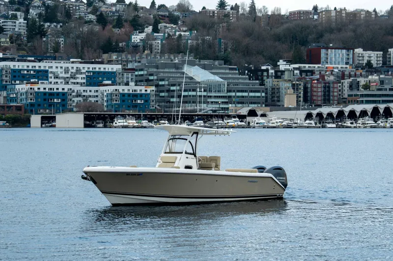 Slide: The Image of 2018 Pursuit C 260 Center Console boat on urban waterfront. - 0