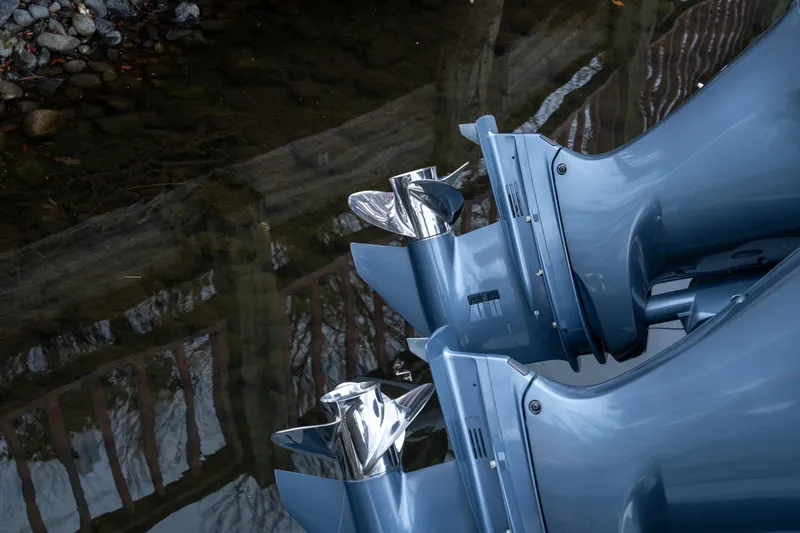Slide: The Image of Twin outboard motors of a 2018 Pursuit C 260 Center Console boat reflected in water. - 11