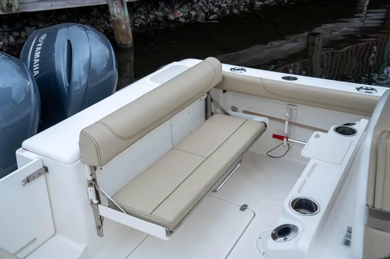 Slide: The Image of 2018 Pursuit C 260 Center Console boat interior with beige seating and Yamaha engines. - 12