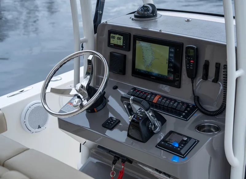 Slide: The Image of 2018 Pursuit C 260 Center Console boat dashboard with navigation and control systems. - 13