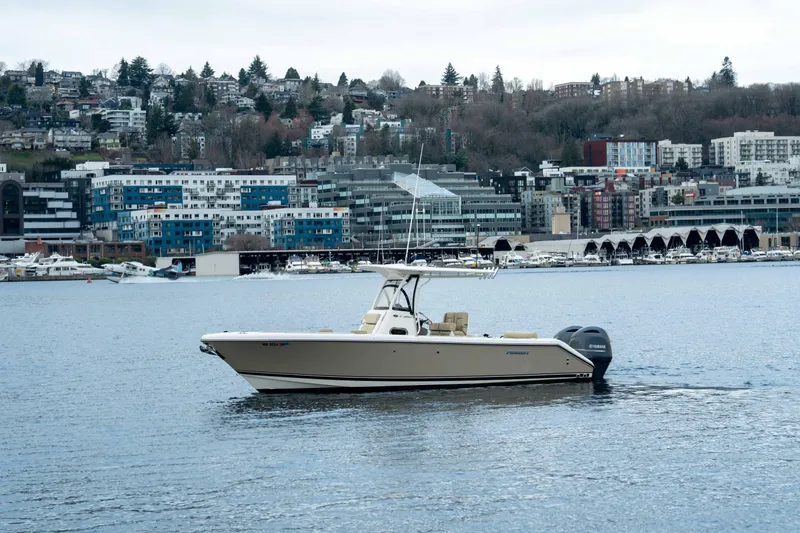 Slide: The Image of 2018 Pursuit C 260 Center Console boat on water with cityscape background. - 5