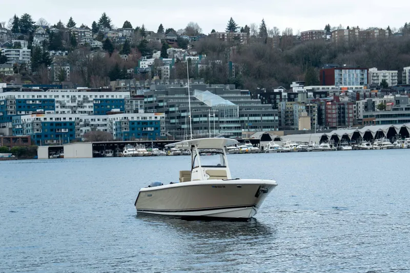 Slide: The Image of 2018 Pursuit C 260 Center Console boat on urban waterfront with cityscape background. - 7