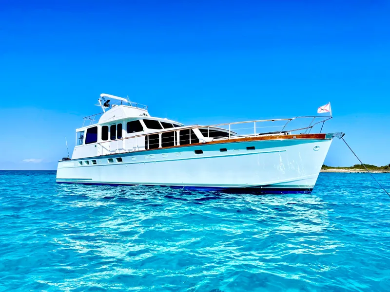 Slide: The Image of Classic 1964 Huckins Atlantic yacht on clear blue water under a bright sky. - 0