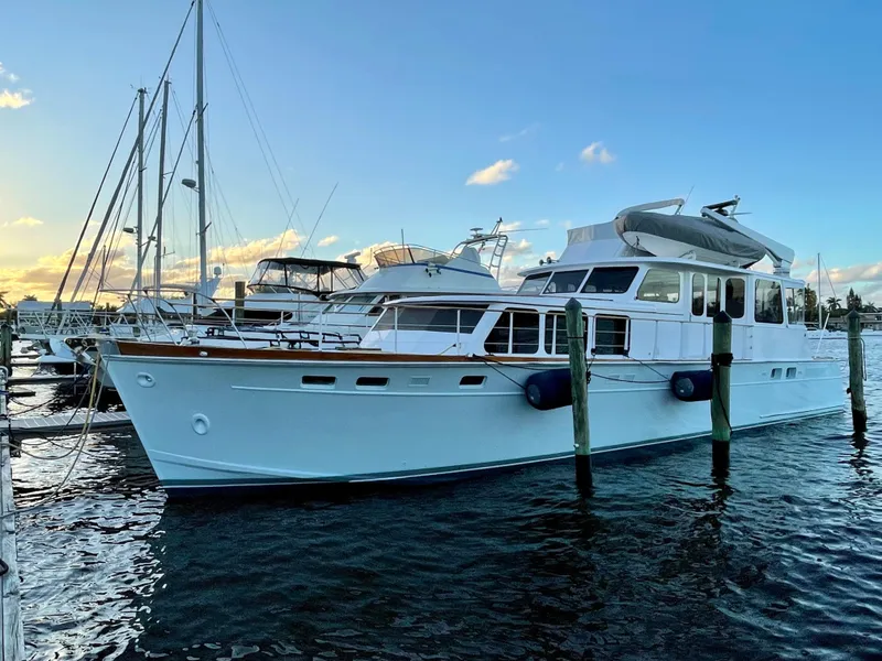 Slide: The Image of 1964 Huckins Atlantic yacht docked at marina during sunset. - 1