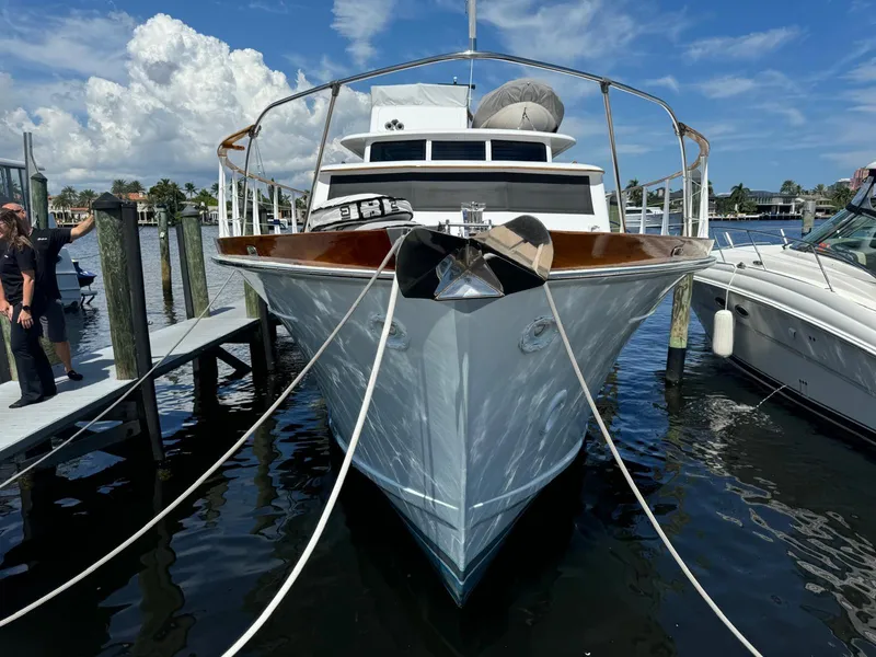 Slide: The Image of 1964 Huckins Atlantic yacht docked at marina, clear sky, calm water. - 10