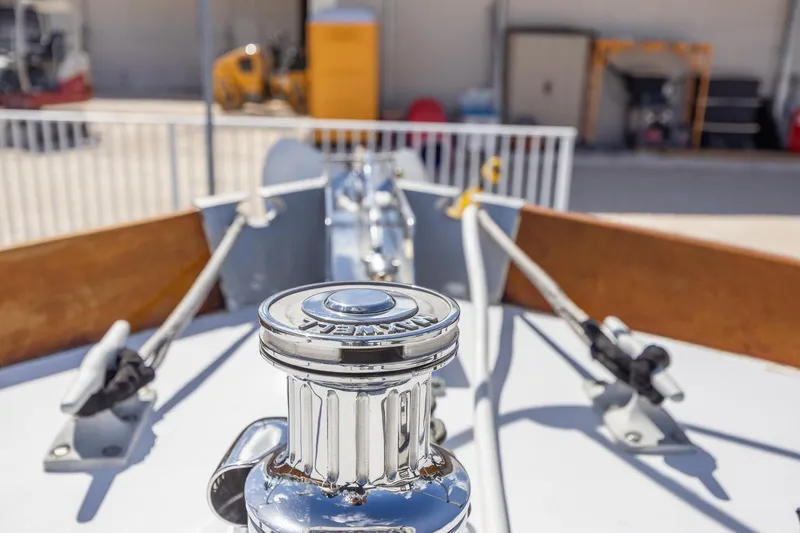Slide: The Image of 1964 Huckins Atlantic yacht deck with chrome winch and ropes. - 11