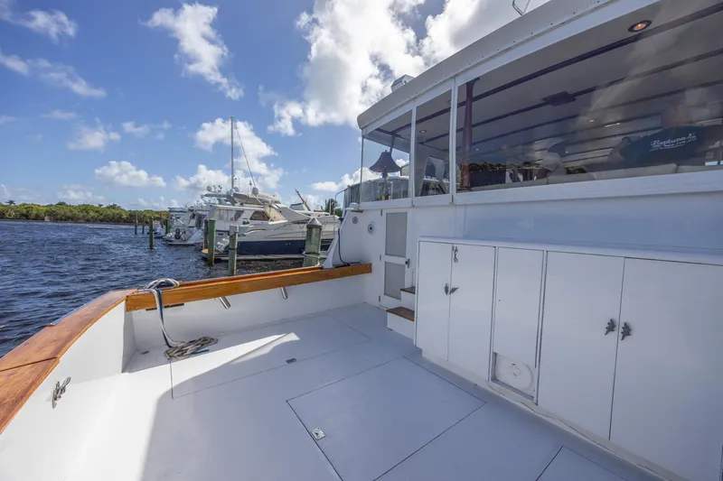 Slide: The Image of 1964 Huckins Atlantic yacht deck with clear skies and marina view. - 16