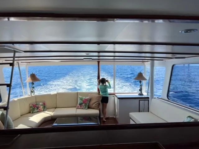 Slide: The Image of Interior of 1964 Huckins Atlantic yacht with ocean view and cozy seating area. - 22