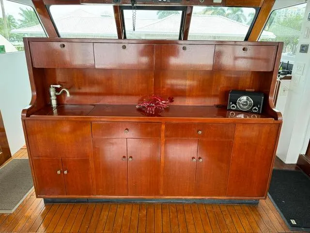 Slide: The Image of 1964 Huckins Atlantic yacht interior with wooden cabinetry and vintage radio. - 28