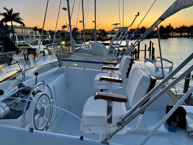 Slide: The Image of 1964 Huckins Atlantic yacht interior at sunset, featuring helm and seating area. - 3