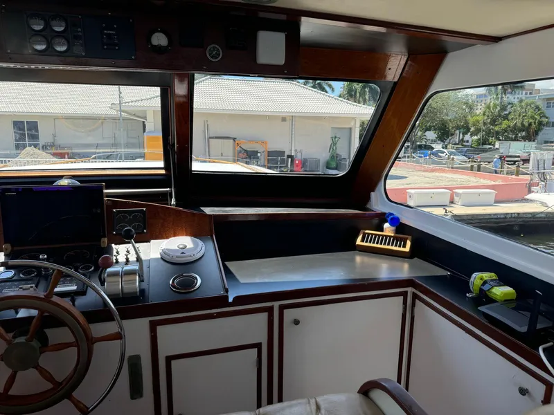 Slide: The Image of Interior view of a 1964 Huckins Atlantic boat cockpit with steering wheel and controls. - 31