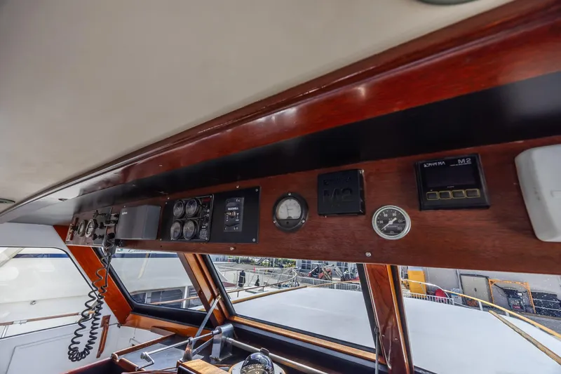 Slide: The Image of 1964 Huckins Atlantic boat dashboard with vintage gauges and controls. - 36