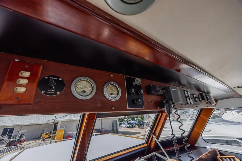 Slide: The Image of 1964 Huckins Atlantic boat dashboard with gauges and controls, showcasing vintage nautical design. - 37