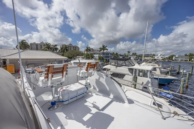 Slide: The Image of 1964 Huckins Atlantic yacht docked at marina under cloudy sky. - 38