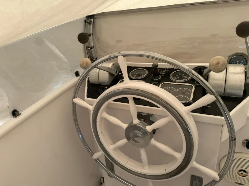 Slide: The Image of 1964 Huckins Atlantic boat steering wheel and dashboard controls. - 40