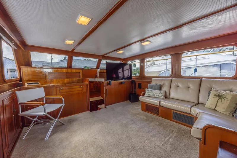 Slide: The Image of Interior of a 1964 Huckins Atlantic yacht with wood paneling and comfortable seating. - 41