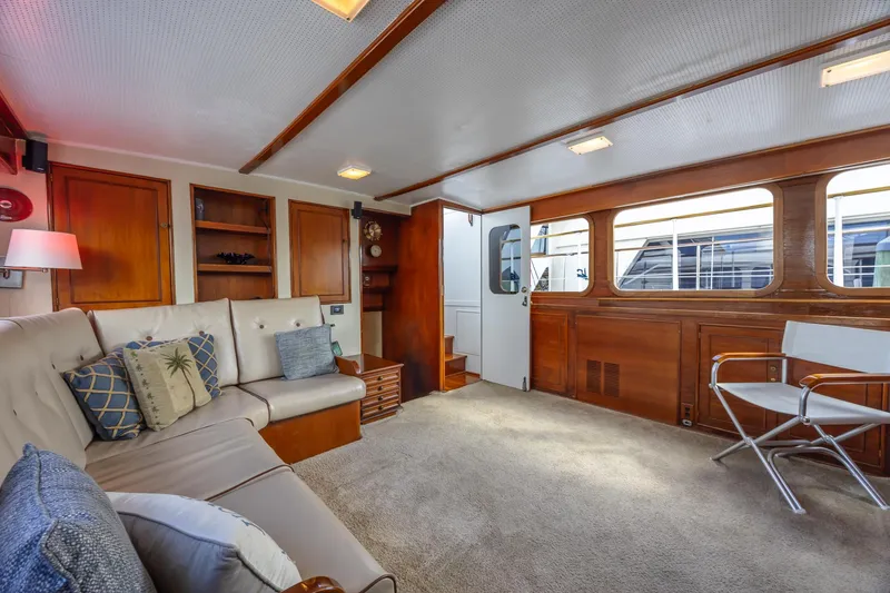 Slide: The Image of Interior of a 1964 Huckins Atlantic yacht, featuring cozy seating and wooden accents. - 43