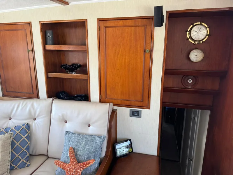Slide: The Image of 1964 Huckins Atlantic interior with wooden cabinets, plush seating, and nautical decor. - 47