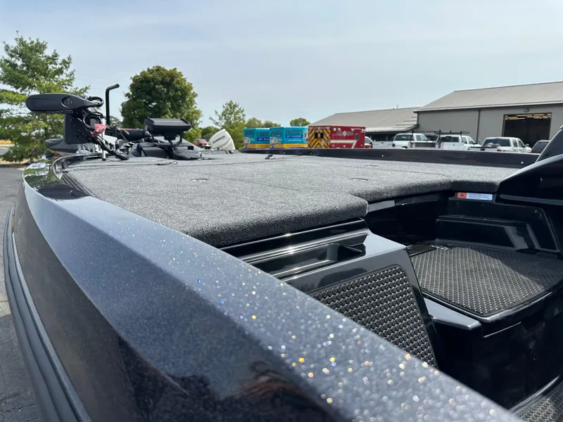 Slide: The Image of 2025 iKon VLX20 boat with sleek design and advanced features, parked outdoors. - 12