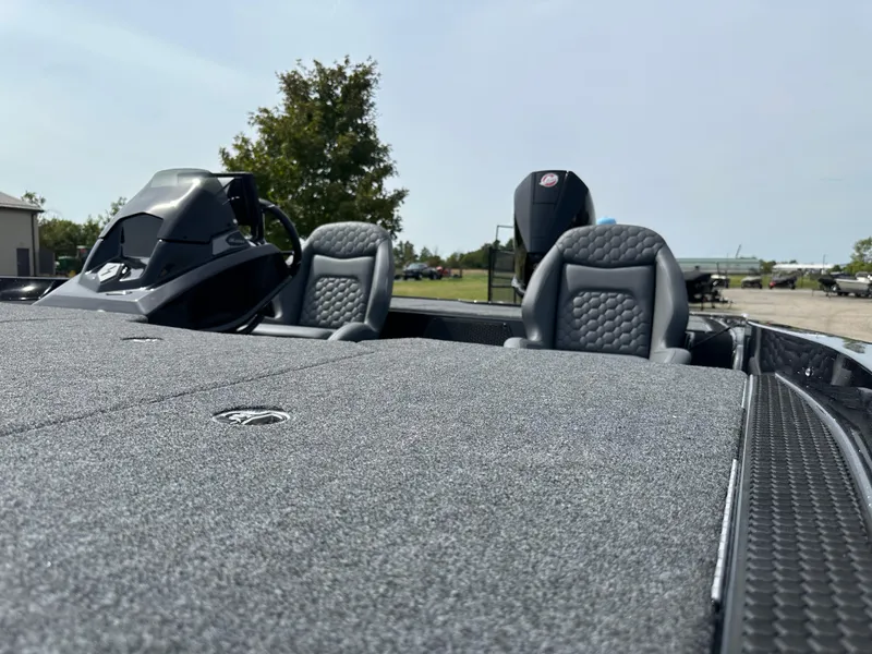 Slide: The Image of 2025 iKon VLX20 boat interior with gray seats and steering console. - 15