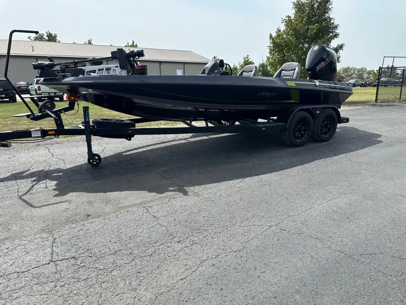 Slide: The Image of 2025 iKon VLX20 boat on trailer, parked outdoors, side view. - 2