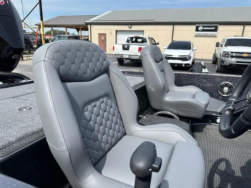 Slide: The Image of iKon VLX20 2025 boat seats with quilted design, parked vehicles in background. - 21