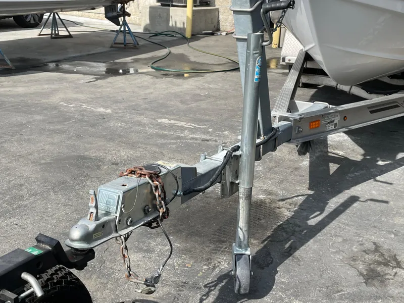 Slide: The Image of Trailer hitch of a 2021 Sea Hunt Ultra 219 boat in a parking area. - 18