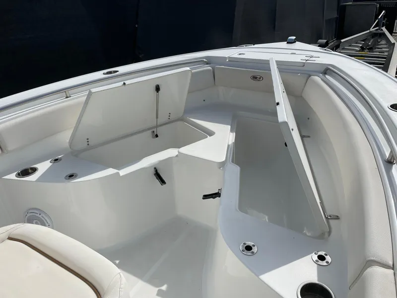 Slide: The Image of 2021 Sea Hunt Ultra 219 boat interior with open storage compartments. - 33