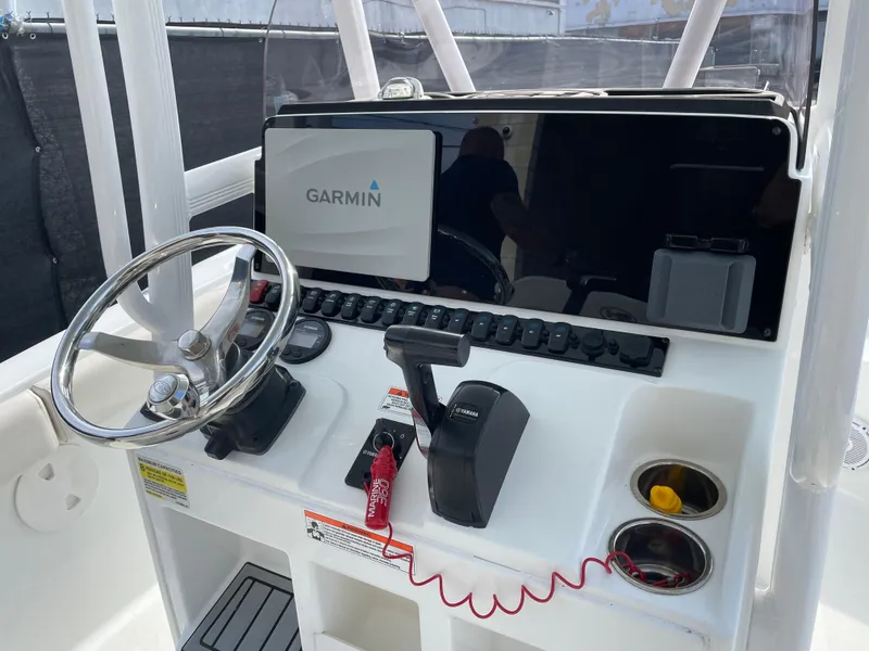 Slide: The Image of 2021 Sea Hunt Ultra 219 boat console with Garmin navigation system and steering wheel. - 37