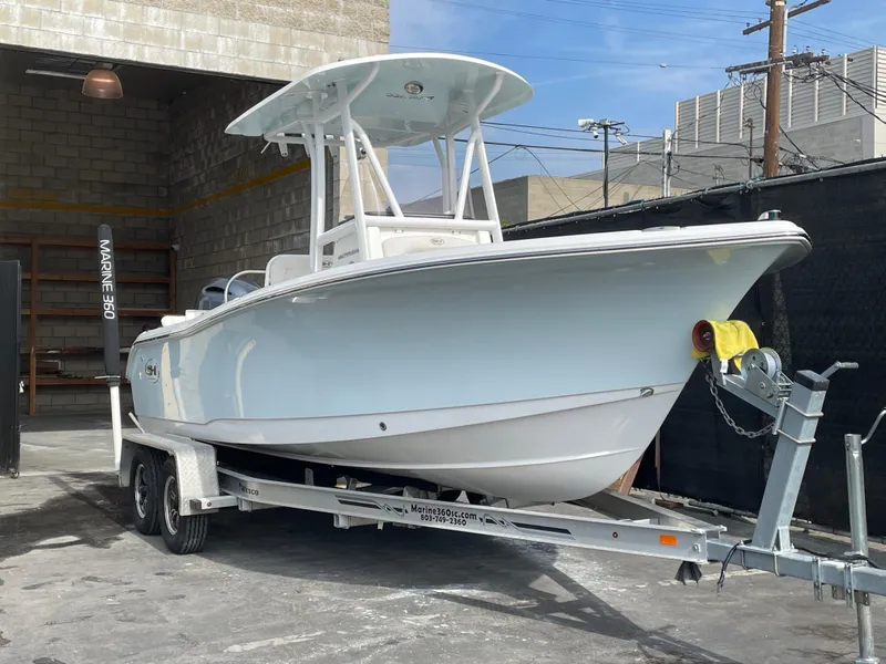 Slide: The Image of 2021 Sea Hunt Ultra 219 boat on trailer in an industrial setting. - 44
