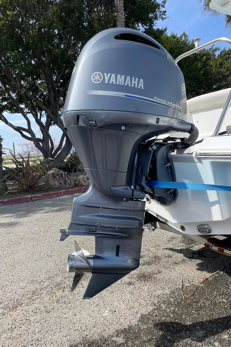 Slide: The Image of 2021 Sea Hunt Ultra 219 with Yamaha outboard motor, parked outdoors. - 46