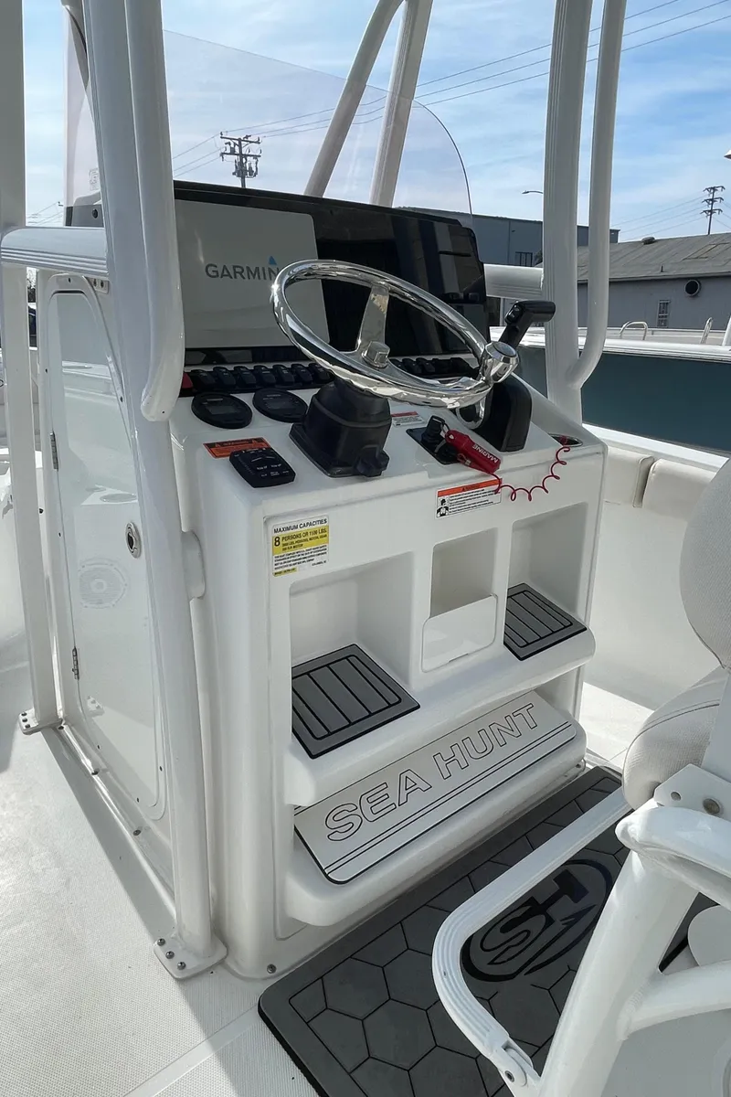 Slide: The Image of 2021 Sea Hunt Ultra 219 boat console with steering wheel and Garmin display. - 48
