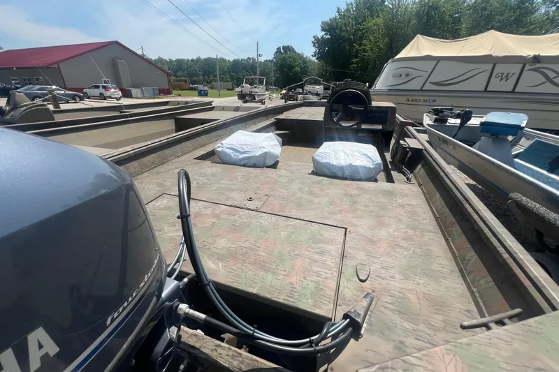 Slide: The Image of 2025 G3 Gator Tough 17 SC boat trailer on gravel lot, sunny day. - 8