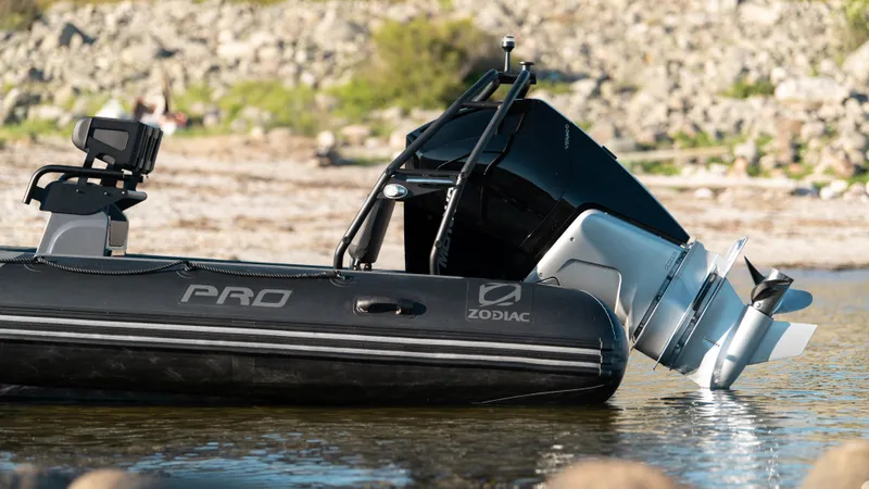 Slide: The Image of 2025 Zodiac Pro 7 inflatable boat with outboard motor in shallow water. - 1